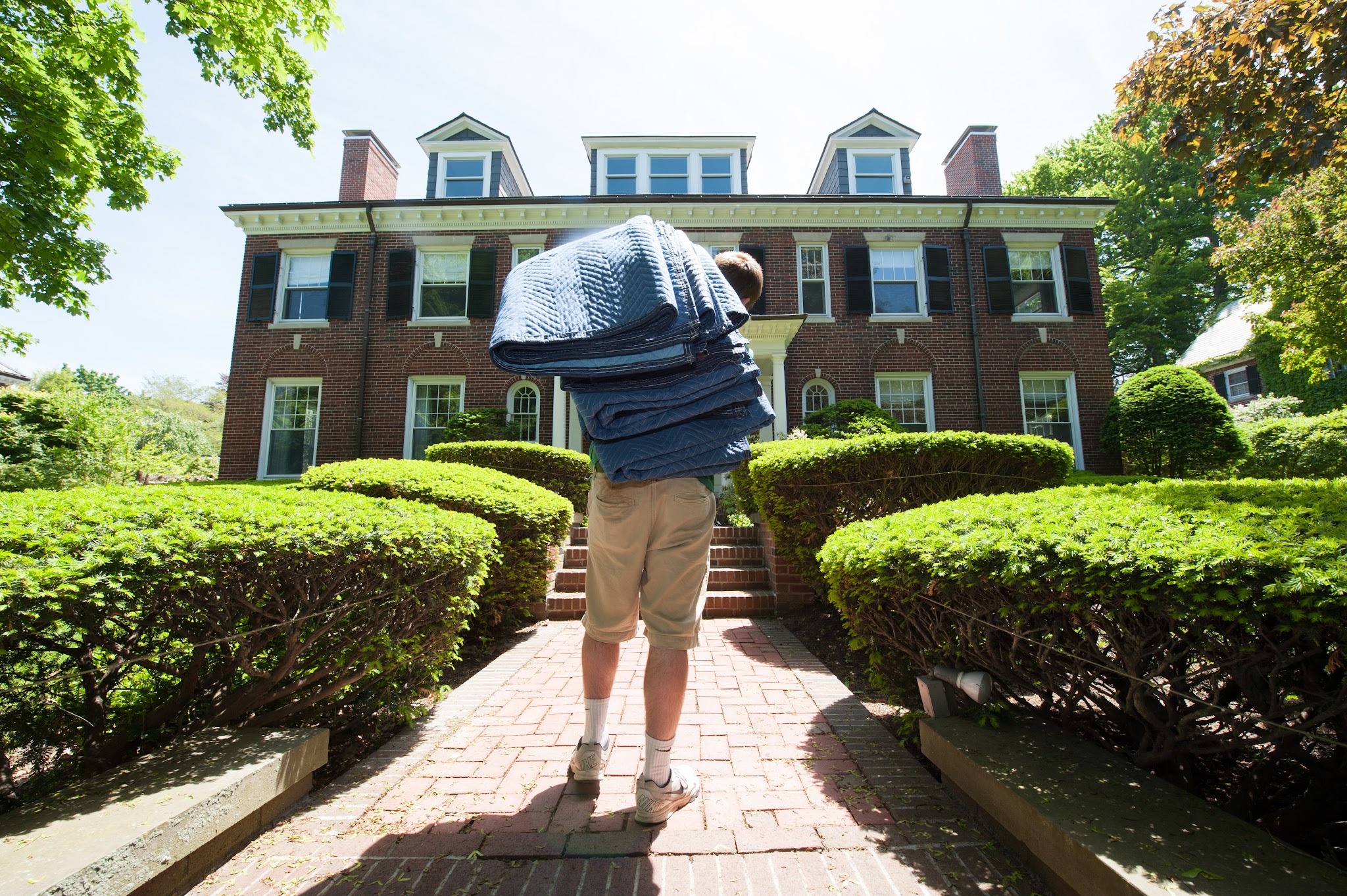 A Mastodon mover carrying a stack of reusable moving pads up to a home